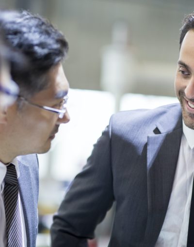 Businessmen and engineers talking in the factory